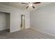 A standard bedroom with a ceiling fan, gray carpet, and a closet, creating a cozy and inviting space at 854 S San Marcos Dr Bldg 6 Dr # D, Apache Junction, AZ 85120
