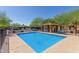 A lovely community pool featuring lounge chairs and a covered seating area for all the residents at 854 S San Marcos Dr Bldg 6 Dr # D, Apache Junction, AZ 85120