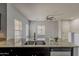 Open kitchen with a stainless steel dishwasher, double sink, and a view of the front yard at 854 S San Marcos Dr Bldg 6 Dr # D, Apache Junction, AZ 85120
