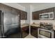 Kitchen featuring stainless steel appliances, dark wood cabinetry, and granite countertops at 854 S San Marcos Dr Bldg 6 Dr # D, Apache Junction, AZ 85120