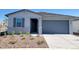 Charming single-story home featuring a gray garage door and shuttered window at 8560 W Yorktown Ct, Florence, AZ 85132