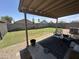 A covered patio and backyard with grass, a privacy wall, and a gravel border at 8673 W Palm Ln, Phoenix, AZ 85037