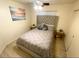 Cozy bedroom featuring a tufted headboard, neutral color palette, and ceiling fan at 8673 W Palm Ln, Phoenix, AZ 85037
