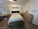 View of a bedroom with a queen-sized bed and matching bedside tables and a window at 8673 W Palm Ln, Phoenix, AZ 85037