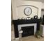 Stylish fireplace with modern decor, a decorative clock, and neutral accents at 8673 W Palm Ln, Phoenix, AZ 85037