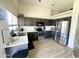 Modern kitchen with stainless steel appliances, dark cabinets, and quartz countertops at 8673 W Palm Ln, Phoenix, AZ 85037