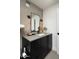 Modern bathroom with a concrete block wall and sleek black vanity at 1111 W University Dr # 1017, Tempe, AZ 85281
