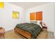 Well-lit bedroom with a comfortable bed, vibrant artwork, and stylish decor at 1111 W University Dr # 1017, Tempe, AZ 85281