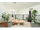 Cozy sitting area with a comfortable lounge chair, potted plants, and a bright, airy atmosphere at 1111 W University Dr # 1017, Tempe, AZ 85281
