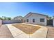 Large concrete patio and xeriscape design in a private backyard with block fence at 1120 W Desert Hollow Dr, San Tan Valley, AZ 85143