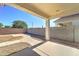 Covered patio overlooks the xeriscaped backyard with gravel and walkway at 1120 W Desert Hollow Dr, San Tan Valley, AZ 85143