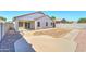 Backyard showcases a covered patio and low maintenance xeriscape design at 1120 W Desert Hollow Dr, San Tan Valley, AZ 85143
