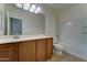 Well-lit bathroom features a vanity with a large mirror and a shower-tub combination at 1120 W Desert Hollow Dr, San Tan Valley, AZ 85143