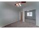 Bedroom with neutral walls, mirrored closet doors and open doorway at 1120 W Desert Hollow Dr, San Tan Valley, AZ 85143