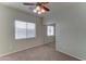 Bedroom with neutral walls, carpet flooring, closet with mirrored doors and ceiling fan at 1120 W Desert Hollow Dr, San Tan Valley, AZ 85143