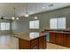 Open kitchen featuring center island, wood cabinetry, granite countertops, and stainless steel appliances at 1120 W Desert Hollow Dr, San Tan Valley, AZ 85143