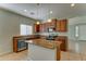 Open kitchen featuring center island, wood cabinetry, granite countertops, and stainless steel appliances at 1120 W Desert Hollow Dr, San Tan Valley, AZ 85143