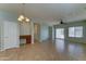 Spacious open concept living area with ceiling fan, tile floors, sliding glass doors, and adjacent desk area at 1120 W Desert Hollow Dr, San Tan Valley, AZ 85143
