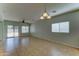 Spacious open concept living area with ceiling fan, tile floors, sliding glass doors, and neutral paint palette at 1120 W Desert Hollow Dr, San Tan Valley, AZ 85143
