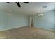 Open living area with tile floors, ceiling fan, and neutral paint provides a versatile space for relaxation and social gatherings at 1120 W Desert Hollow Dr, San Tan Valley, AZ 85143