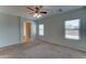 Cozy main bedroom boasting plush carpet, ceiling fan, and bright windows to create a tranquil personal oasis at 1120 W Desert Hollow Dr, San Tan Valley, AZ 85143