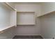 Spacious walk-in closet with wooden shelving and carpet flooring at 1120 W Desert Hollow Dr, San Tan Valley, AZ 85143