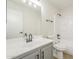 Clean bathroom featuring white fixtures, gray cabinets and matte black hardware at 12813 W Paradise Dr, El Mirage, AZ 85335