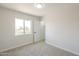 Bedroom featuring a large window, and a walk-in closet at 12813 W Paradise Dr, El Mirage, AZ 85335