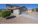 Inviting home featuring a neutral color palette, tile roof, attached garage, and low maintenance desert landscaping at 12813 W Paradise Dr, El Mirage, AZ 85335