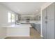 Open kitchen with stainless steel appliances, gray cabinets, quartz countertops, and island with sink and breakfast bar at 12813 W Paradise Dr, El Mirage, AZ 85335