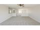 Open-concept living room featuring neutral walls and plush carpeting at 12813 W Paradise Dr, El Mirage, AZ 85335
