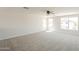 Large living room with lots of natural light and neutral carpet at 12813 W Paradise Dr, El Mirage, AZ 85335