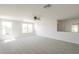 Spacious living room boasts lots of natural light and neutral carpeting at 12813 W Paradise Dr, El Mirage, AZ 85335