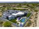 Aerial view of a luxury estate featuring a pool, lush landscaping, modern architecture, and mountain views at 13074 E Saddlehorn Trl, Scottsdale, AZ 85259