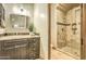 Bathroom with dark wood vanity, walk-in shower and travertine flooring at 13074 E Saddlehorn Trl, Scottsdale, AZ 85259