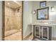 A stylish bathroom with stone tile and a glass-enclosed shower at 13074 E Saddlehorn Trl, Scottsdale, AZ 85259