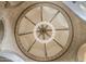 Elegant chandelier hangs from a stunning rotunda ceiling with detailed architectural design at 13074 E Saddlehorn Trl, Scottsdale, AZ 85259