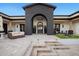Courtyard view featuring an arched entryway, tile, and outdoor seating at 13074 E Saddlehorn Trl, Scottsdale, AZ 85259