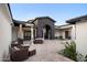 Inviting courtyard featuring stone archway, travertine tile, and outdoor seating area at 13074 E Saddlehorn Trl, Scottsdale, AZ 85259