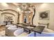 Elegant dining room features a modern chandelier, statues, and comfortable seating for formal gatherings at 13074 E Saddlehorn Trl, Scottsdale, AZ 85259