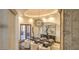 Chic dining room with statement chandelier, sculpture accents, and French doors opening to outdoor living space at 13074 E Saddlehorn Trl, Scottsdale, AZ 85259