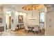 Elegant dining room with designer chandelier, stone flooring, and comfortable seating, perfect for dinner gatherings at 13074 E Saddlehorn Trl, Scottsdale, AZ 85259