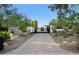 Long, paved driveway leading to a gate and desert landscaping at 13074 E Saddlehorn Trl, Scottsdale, AZ 85259