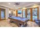 A spacious game room with a pool table, wet bar, and French doors to the outdoors at 13074 E Saddlehorn Trl, Scottsdale, AZ 85259