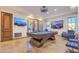 A billiard room featuring a stylish pool table, mounted TVs, and comfortable seating at 13074 E Saddlehorn Trl, Scottsdale, AZ 85259