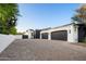 Exterior of home featuring a large garage with dark wood doors and a paved driveway at 13074 E Saddlehorn Trl, Scottsdale, AZ 85259