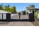 Wrought iron gate flanked by stone pillars at the entrance of the property at 13074 E Saddlehorn Trl, Scottsdale, AZ 85259