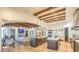 Spacious kitchen with wooden beams, double islands, stainless appliances, and open floor plan to living room at 13074 E Saddlehorn Trl, Scottsdale, AZ 85259
