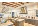Gourmet kitchen featuring custom cabinets, a stainless hood, an island, and professional appliances at 13074 E Saddlehorn Trl, Scottsdale, AZ 85259