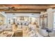 Expansive living room with beamed ceilings, open to kitchen and backyard, with plush seating at 13074 E Saddlehorn Trl, Scottsdale, AZ 85259